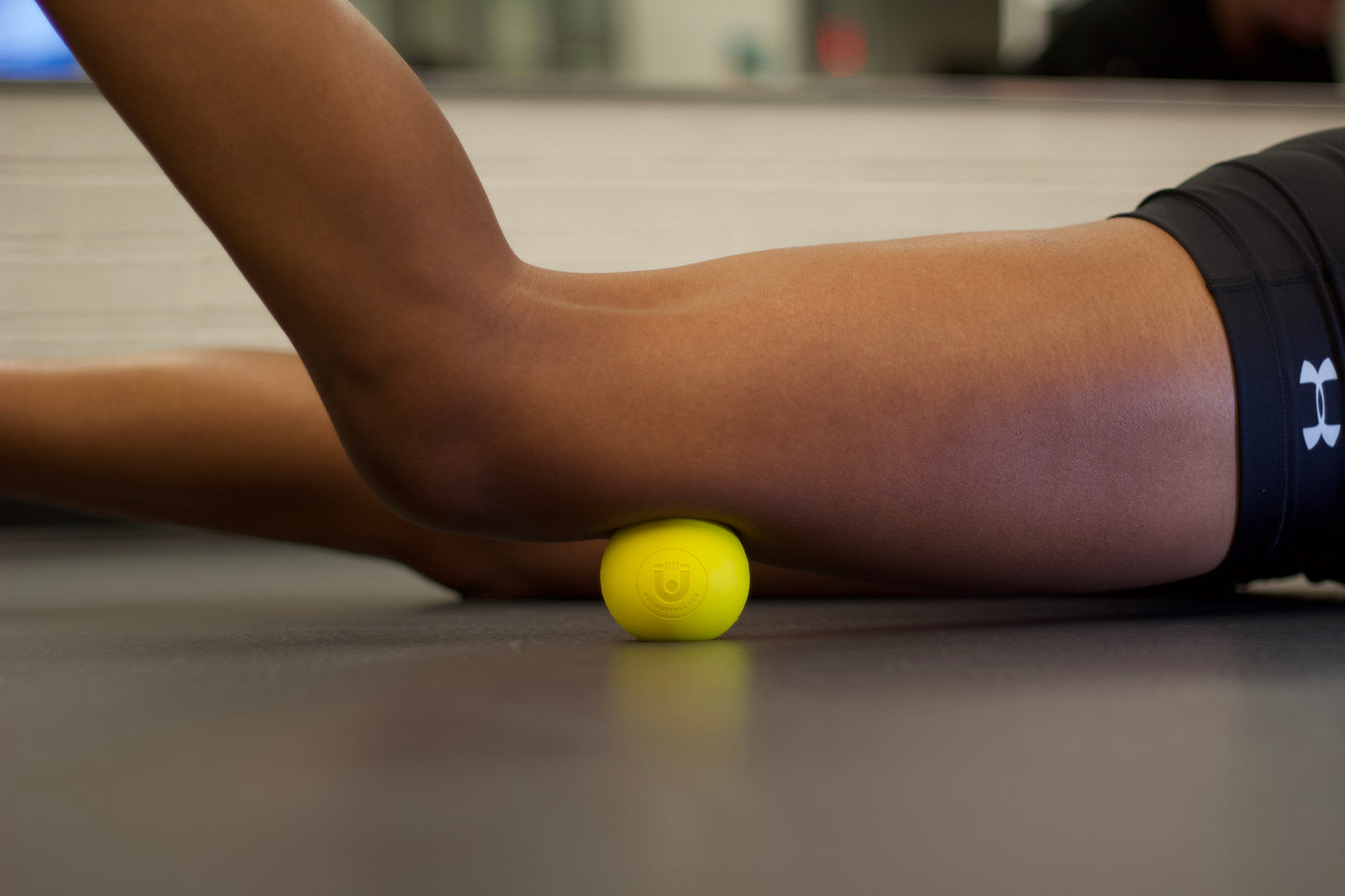 yellow massage ball use on thigh