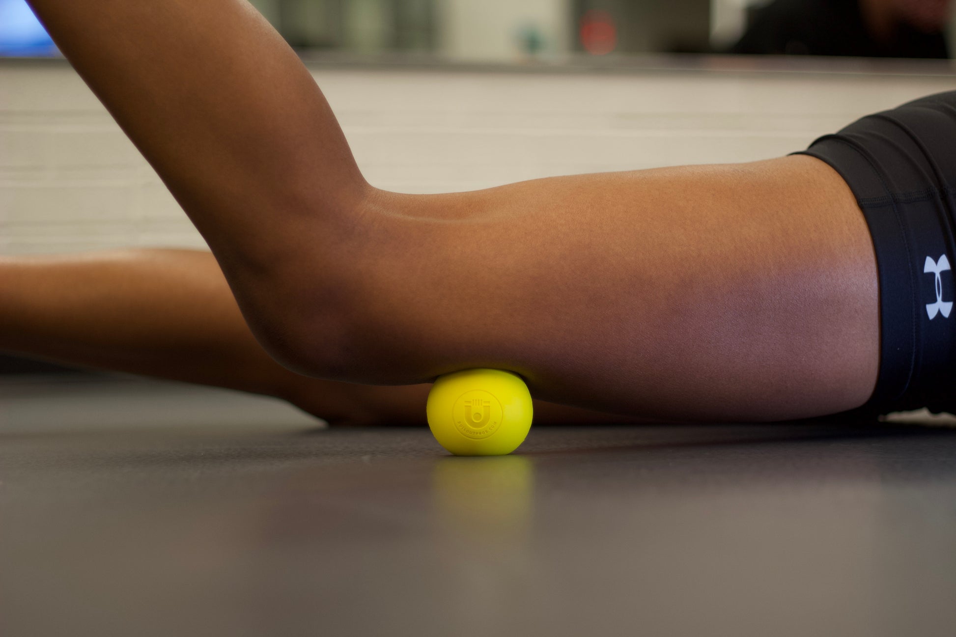 yellow massage ball use on thigh