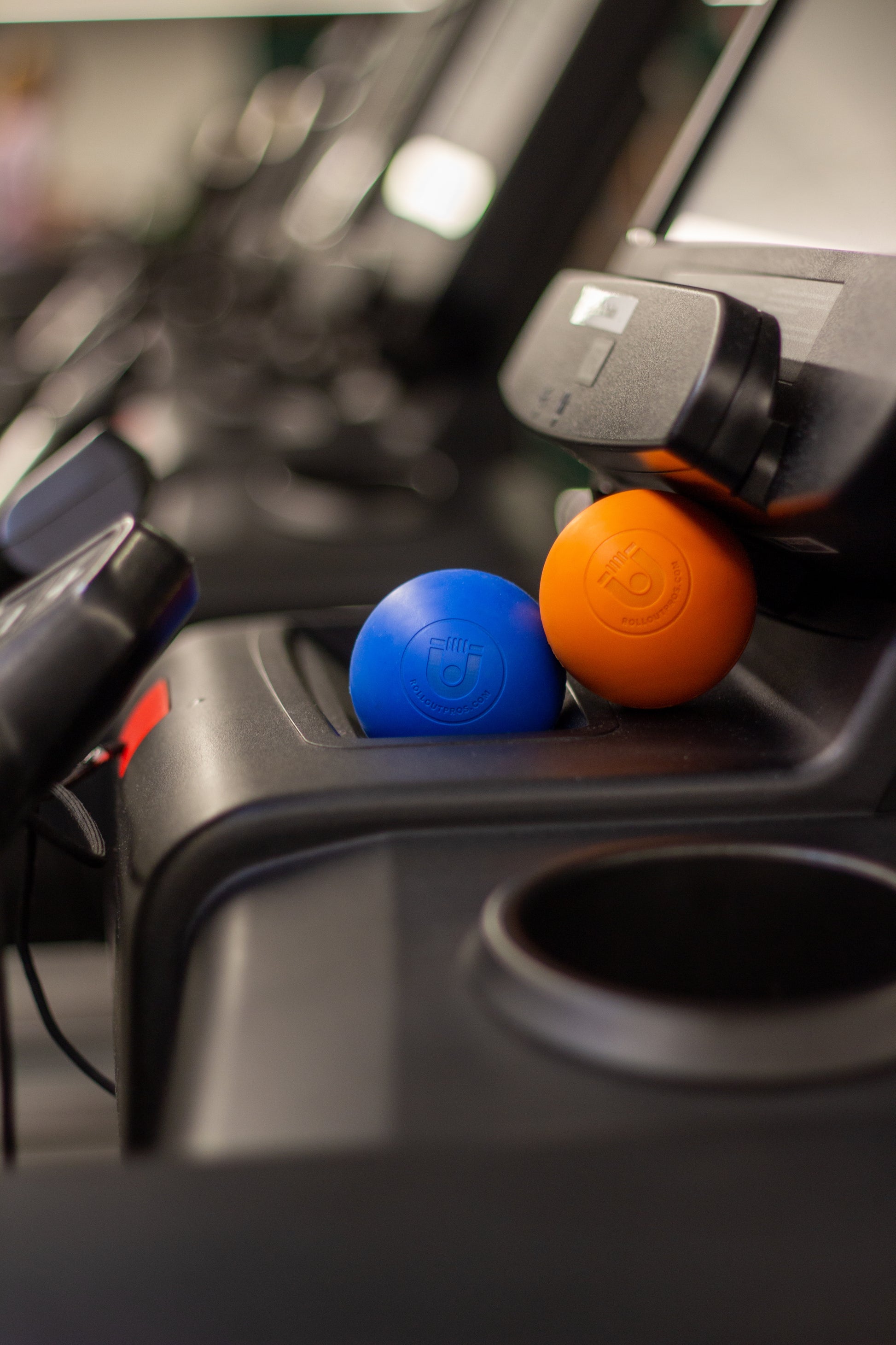 orange and blue massage balls on treadmill